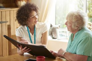 A professional guiding an elderly woman on SMSF comparison