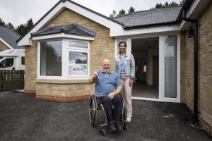 A person with disability excited after acquiring NDIS property
