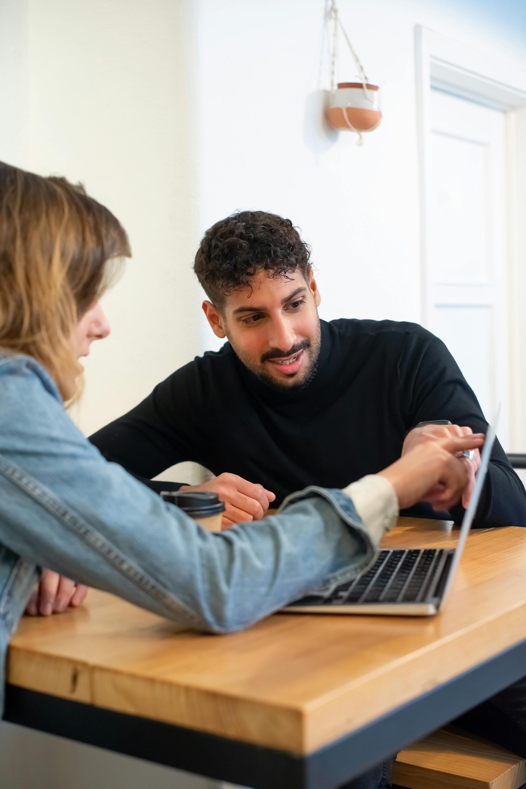 Australian expat reviewing home loan options online with RateBuster while living overseas, comparing interest rates and mortgage features on a laptop.